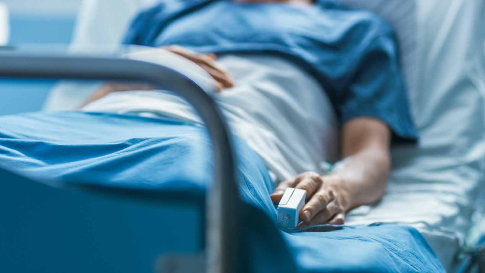 A person lying in a hospital bed, symbolizing the health risks linked to lifestyle diseases like heart disease, diabetes, and obesity in South Africa.